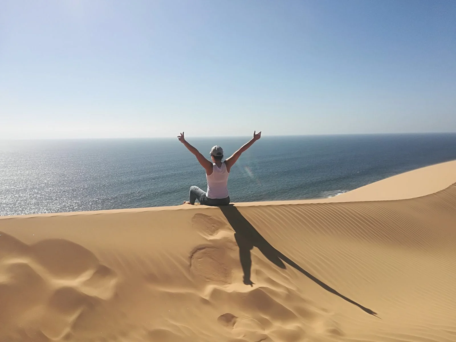 A student looking across the dunes towards the Atlantic Ocean